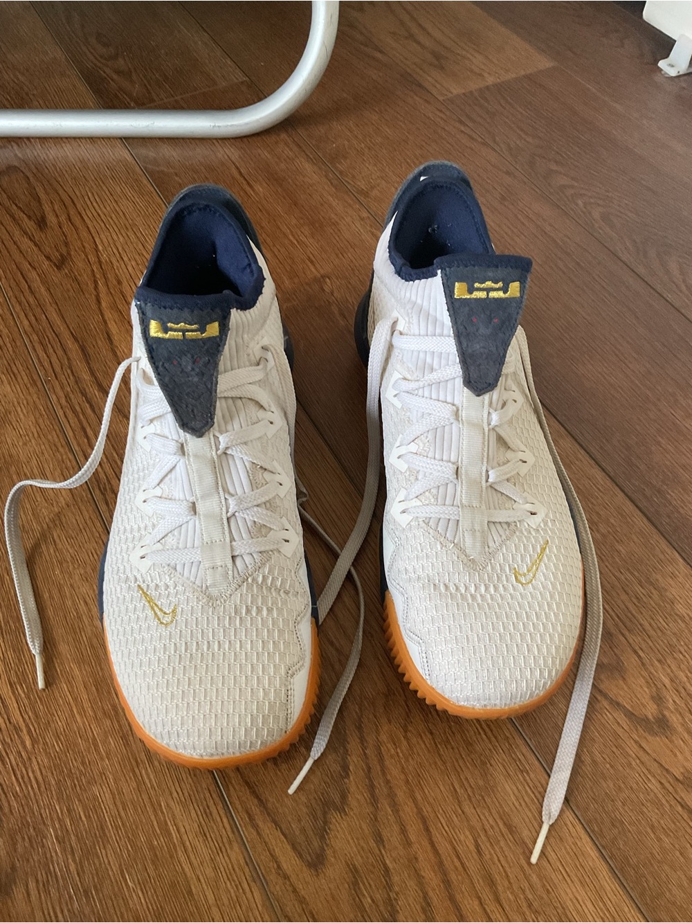 Nike Air Men’s White and Navy Basketball Sneakers with Orange Sole Accents